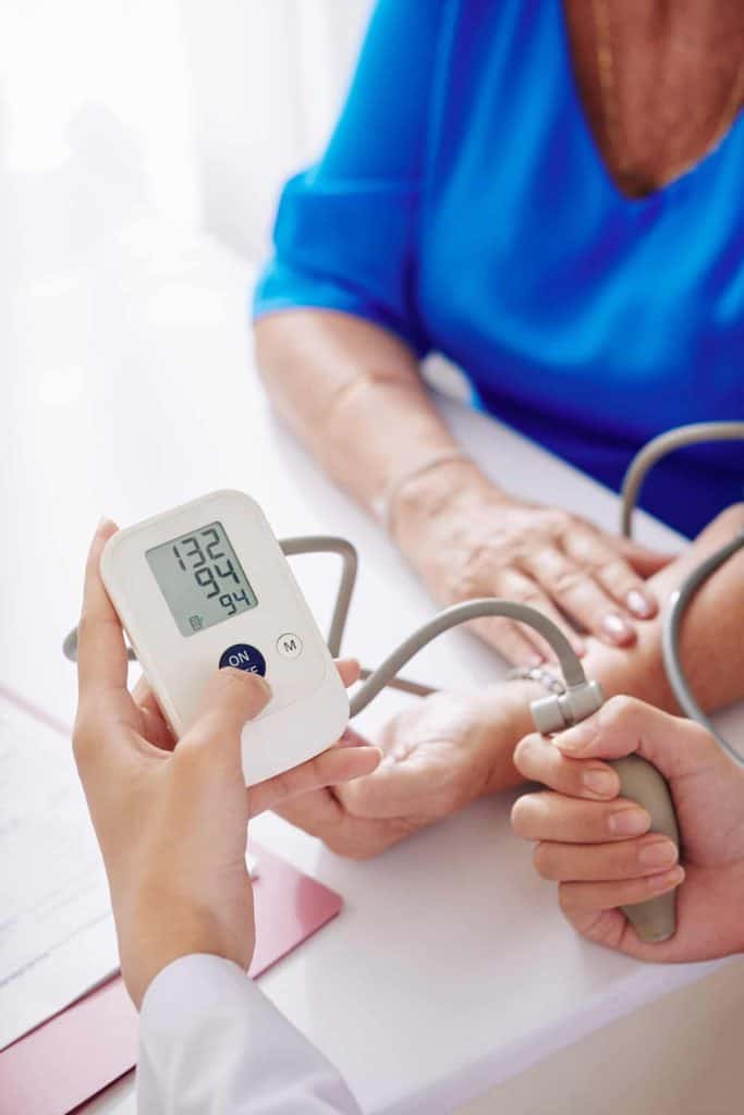 GP checking blood pressure | heart disease symptoms