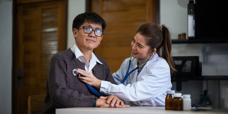 Heart doctor in Singapore examining a patient with a stethoscope during a heart health checkup.
