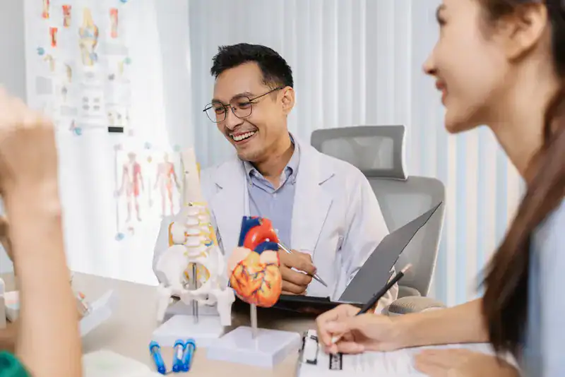 Cardiologist in Singapore explaining heart artery blockage and symptoms to patients.