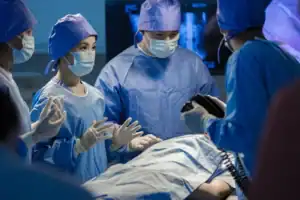Cardiologist team treating a heart artery blockage in a Singapore operating room.