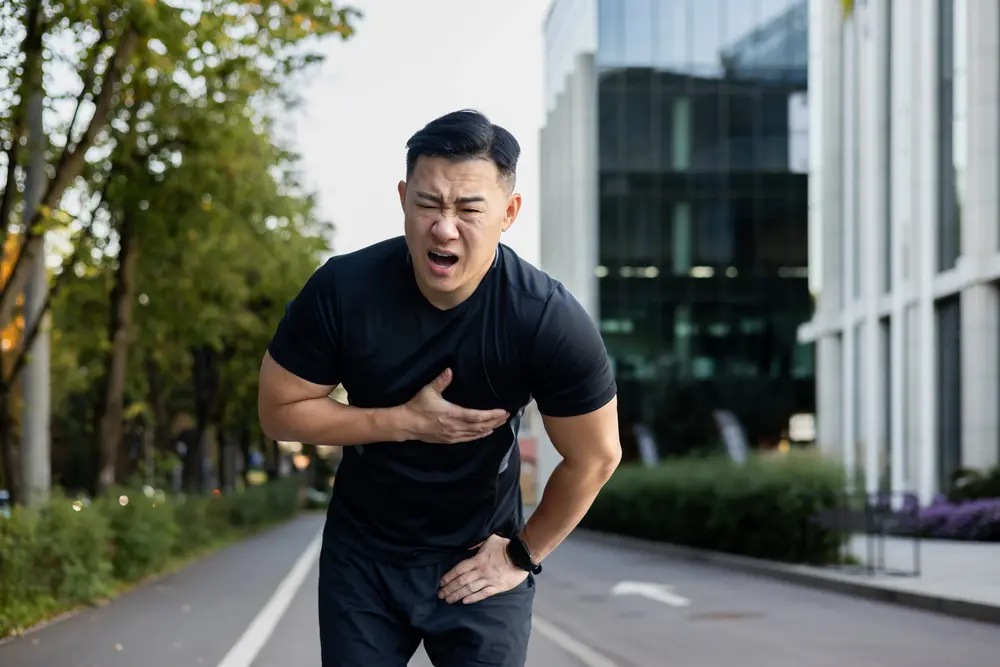 Man experiencing chest pain while running, possible heart attack symptoms in Singapore