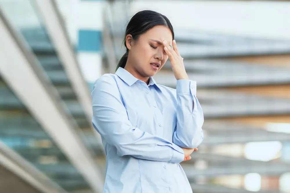 Woman feeling fatigued and dizzy, possible early symptoms of heart disease