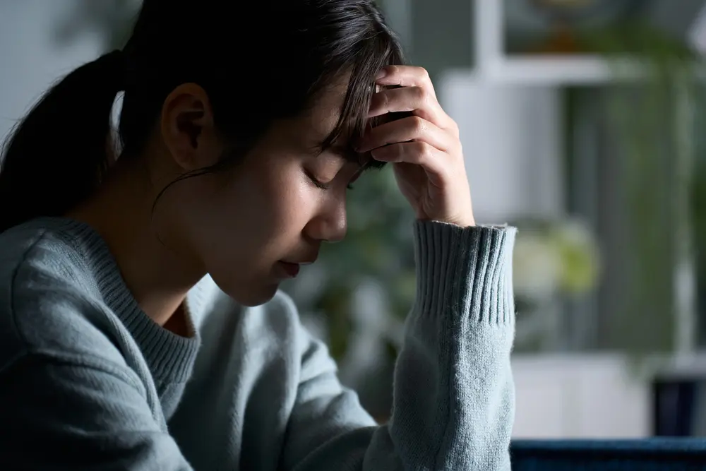 Young woman experiencing stress and fatigue, showing the link between mental health and heart disease risk