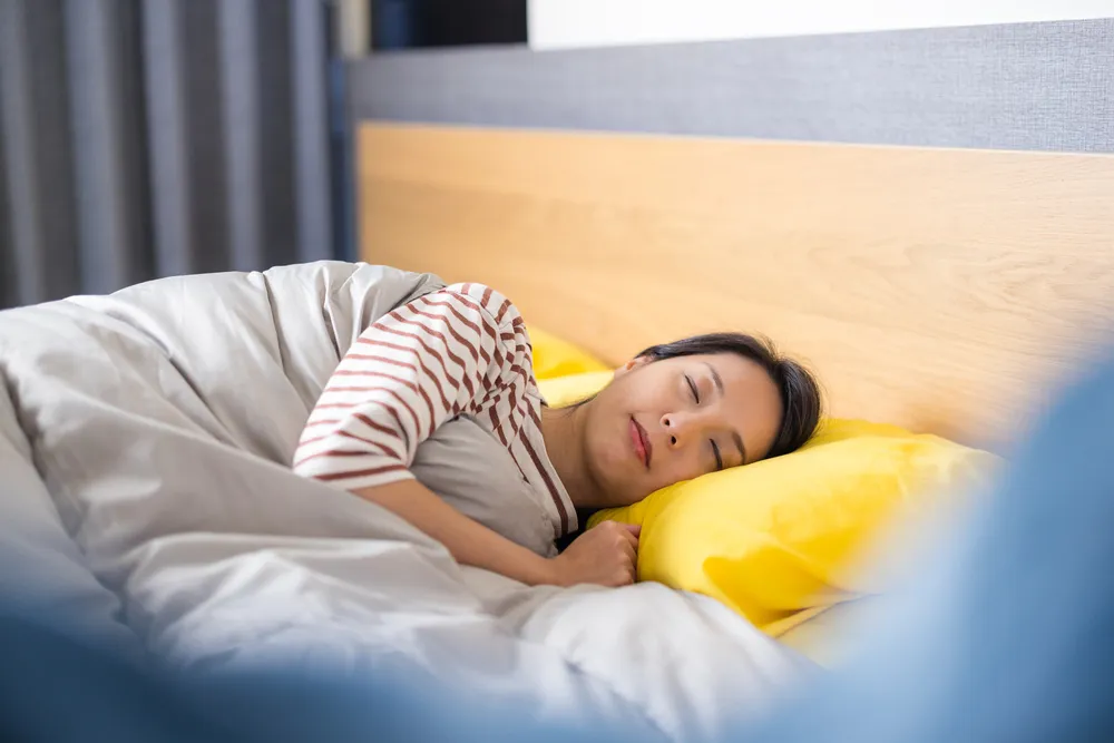 Woman sleeping peacefully, showing importance of good sleep for heart health